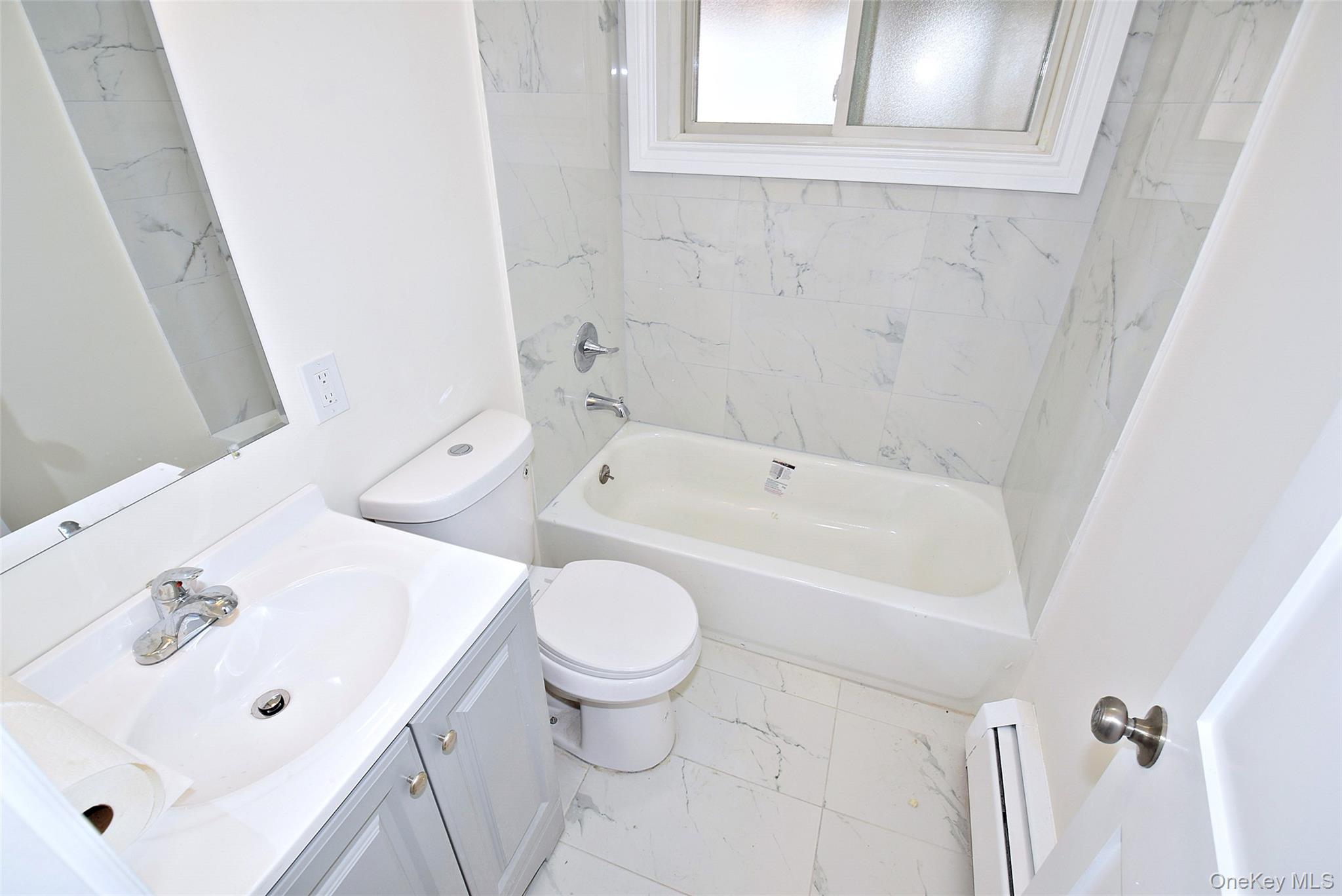 144-24 Village Road, Unit 67B Queens, NY 11435 - Photo 11 of 17 a bathroom with a sink and a bathtub