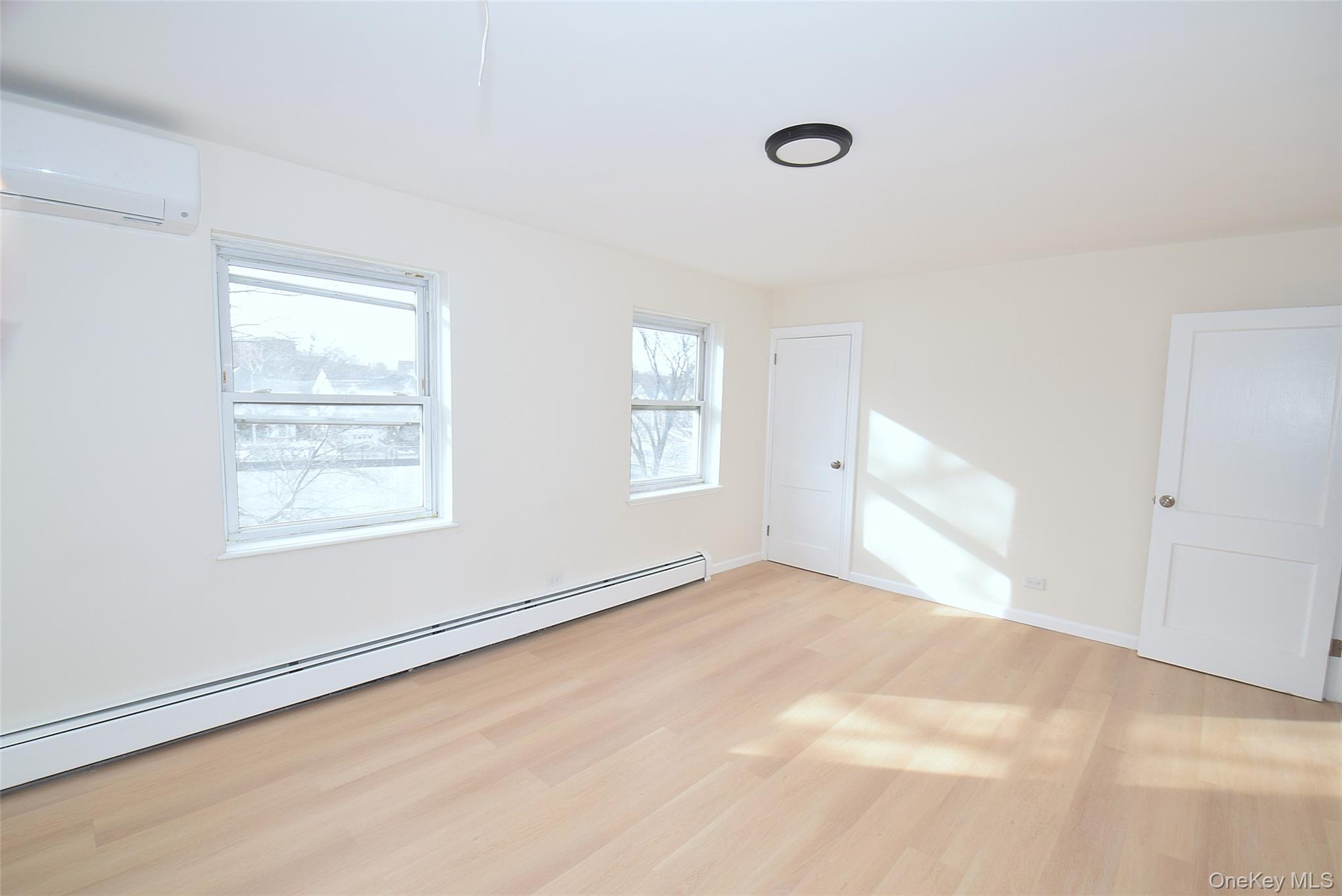 144-24 Village Road, Unit 67B Queens, NY 11435 - Photo 12 of 17 an empty room with windows