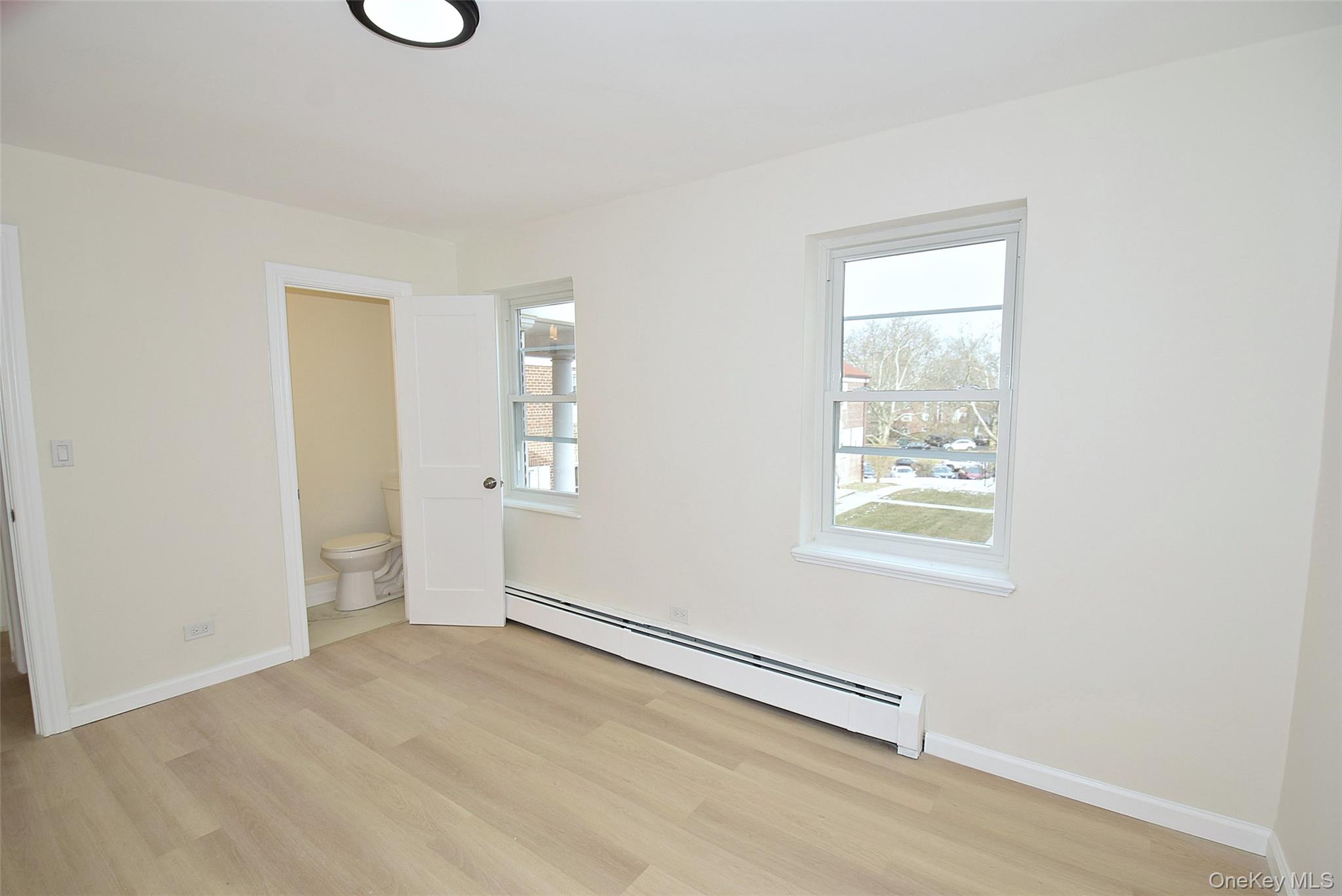 144-24 Village Road, Unit 67B Queens, NY 11435 - Photo 14 of 17 an empty room with windows