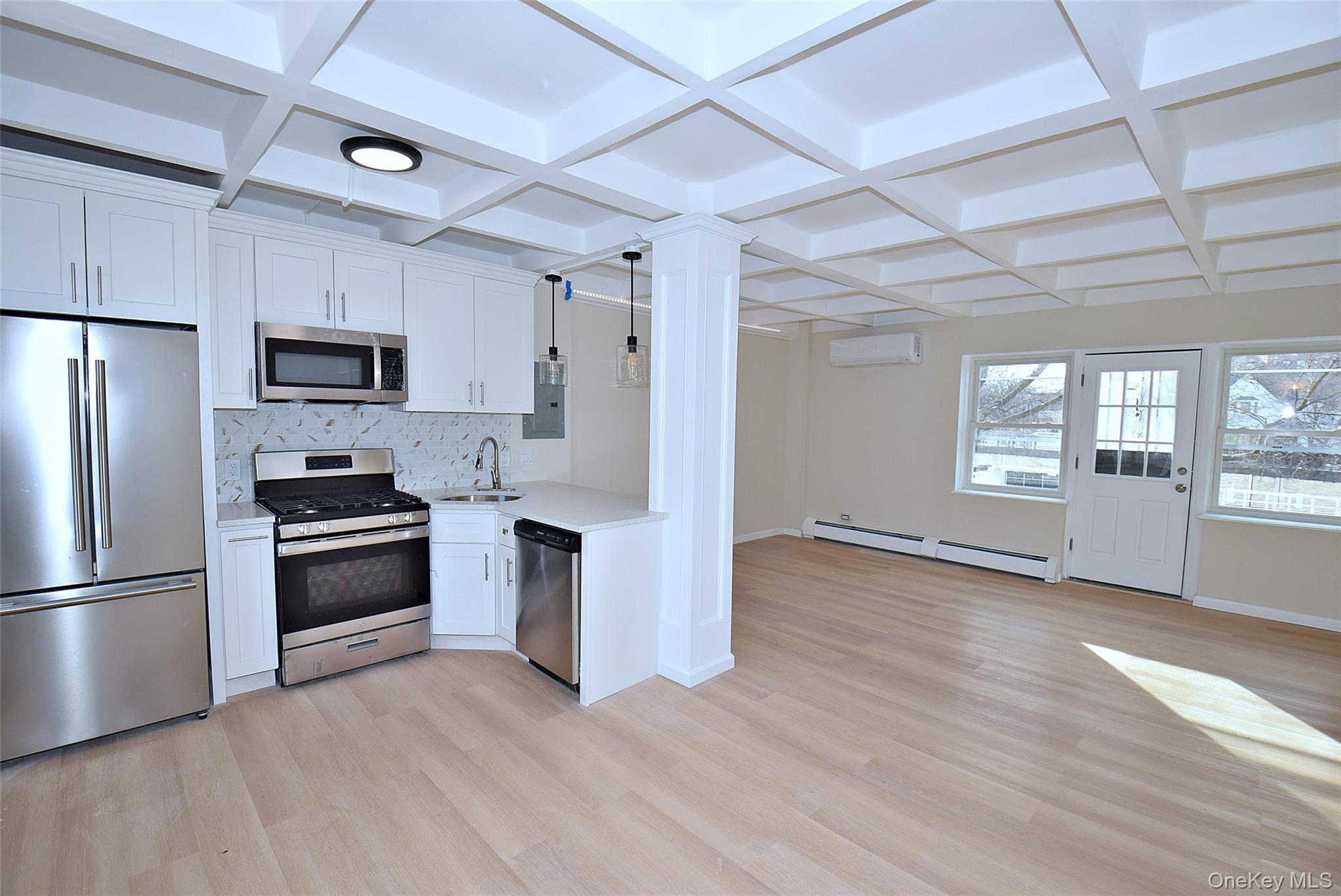 144-24 Village Road, Unit 67B Queens, NY 11435 - Photo 6 of 17 a kitchen with stainless steel appliances granite countertop a refrigerator microwave and stove