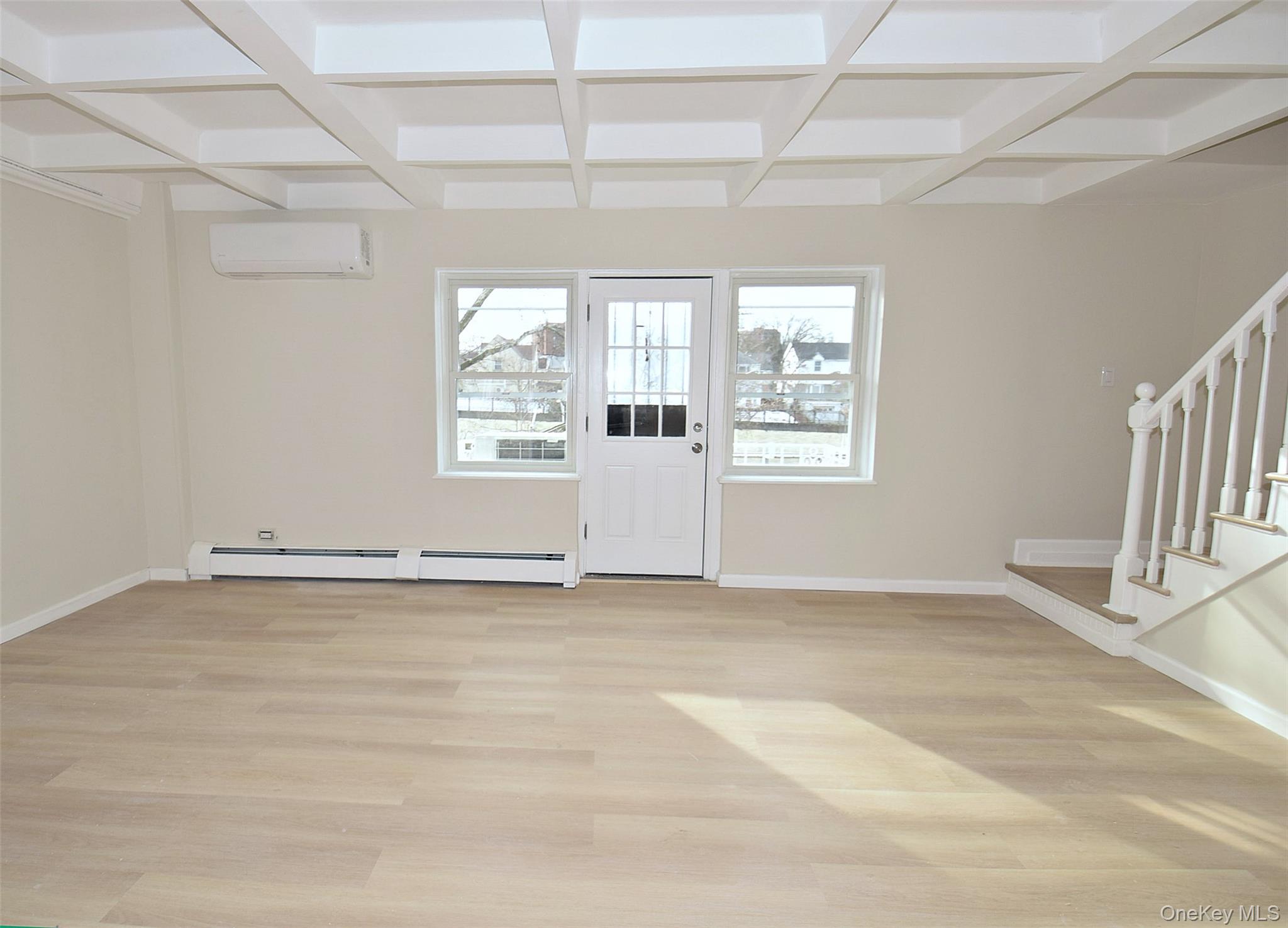 144-24 Village Road, Unit 67B Queens, NY 11435 - Photo 8 of 17 an empty room with wooden floor and windows