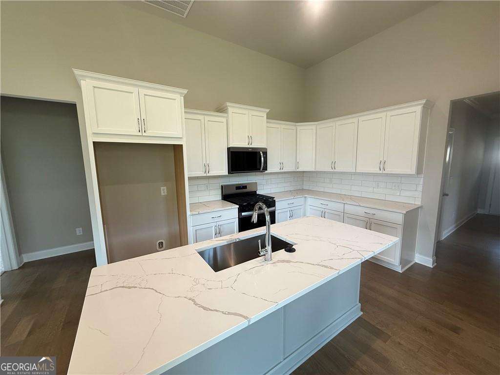 352 Lakeside Drive Canton, GA 30115 - Photo 7 of 16 a kitchen with granite countertop a sink stove and refrigerator