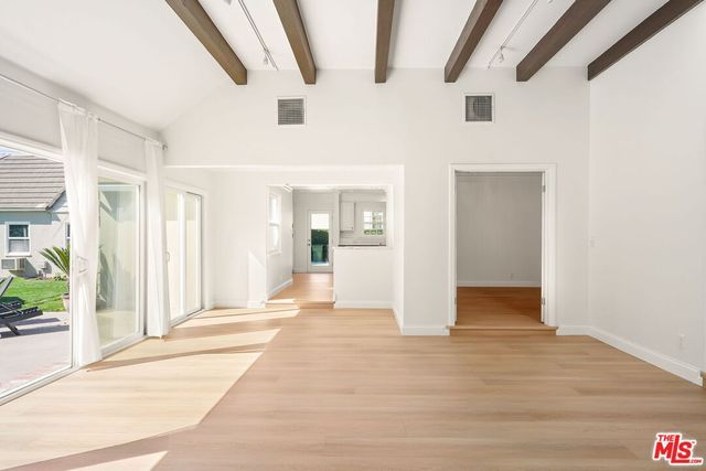 a view of an entryway with wooden floor and door