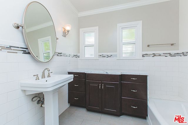 a bathroom with a sink vanity and mirror