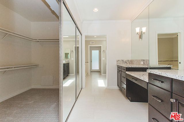 a bathroom with a double vanity sink a toilet and a mirror