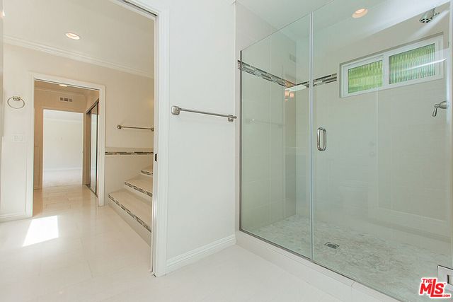 a bathroom with a shower and a glass door