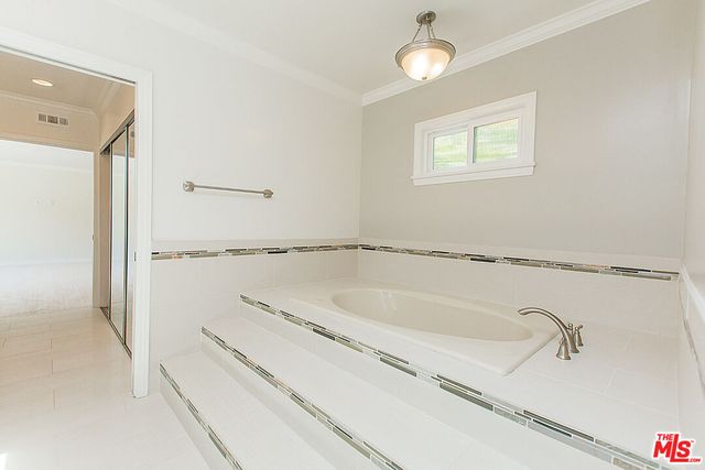 a bathroom with a tub and a shower