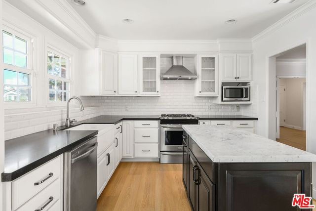 a kitchen with a sink stove and microwave