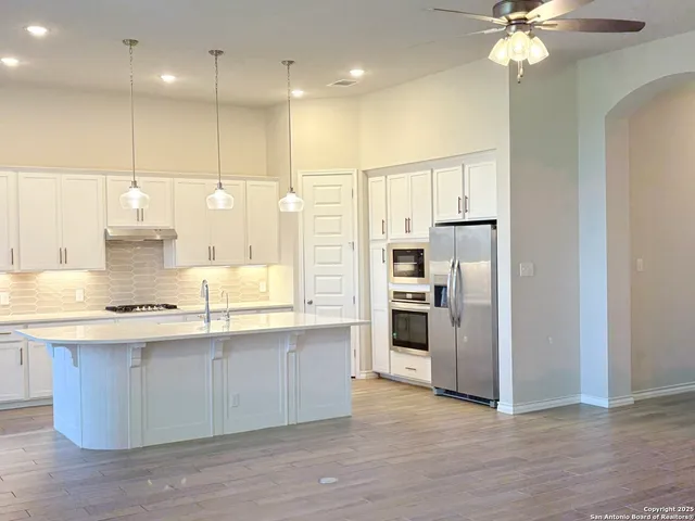 a kitchen with stainless steel appliances a refrigerator sink and stove