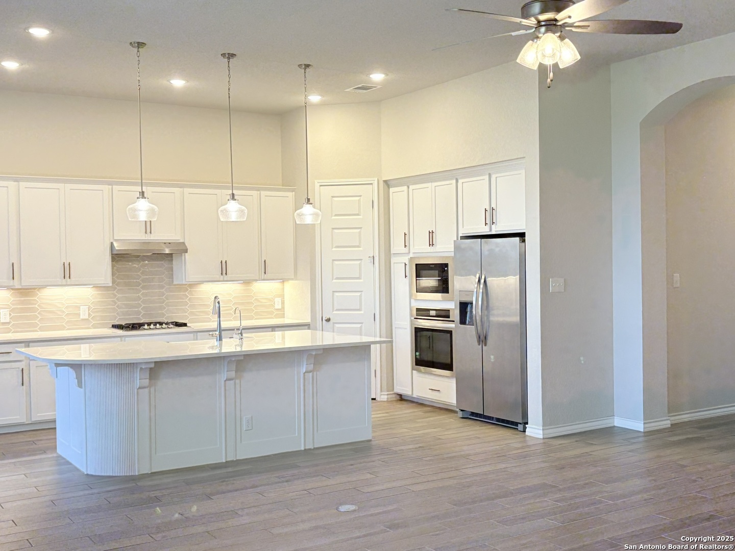 1567 Terrys Gate Road New Braunfels, TX 78132 - Photo 14 of 30 a kitchen with stainless steel appliances a refrigerator sink and stove