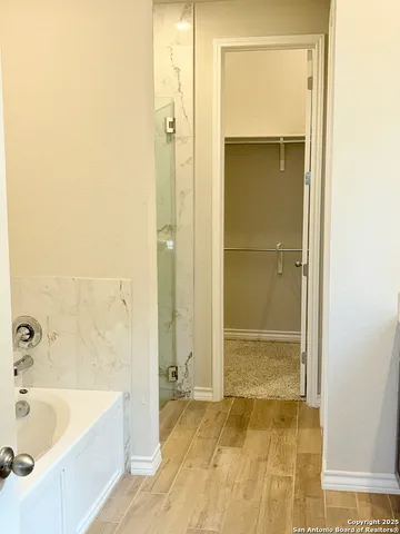 a bathroom with a bathtub and a shower