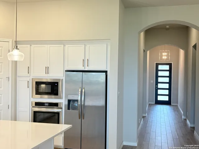 a kitchen with stainless steel appliances a refrigerator sink and cabinets