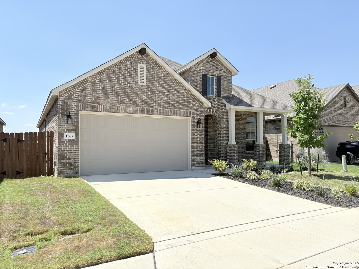 1567 Terrys Gate Road New Braunfels, TX 78132 - Photo 2 of 30 a view of a house with a small yard and wooden fence