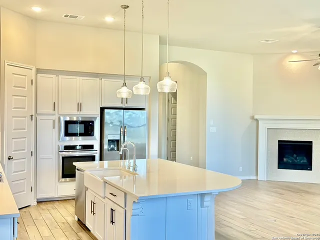 a kitchen with kitchen island a sink stainless steel appliances and cabinets