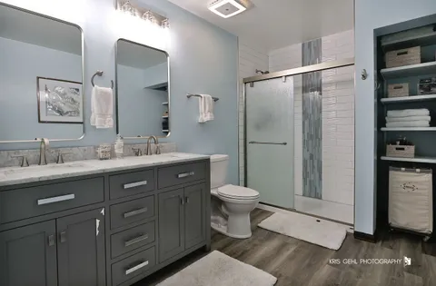 a bathroom with a toilet a sink and glass door