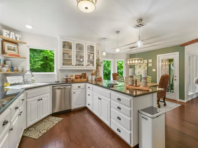 a kitchen with sink and cabinets