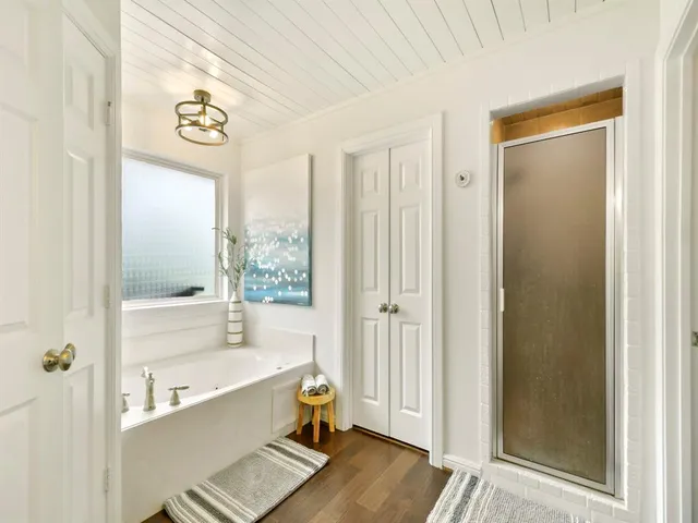 a spacious bathroom with a bathtub and a shower