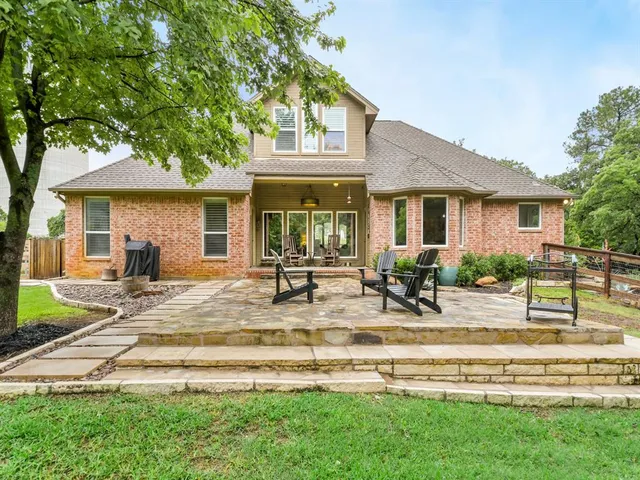 a view of a house with backyard porch and sitting area