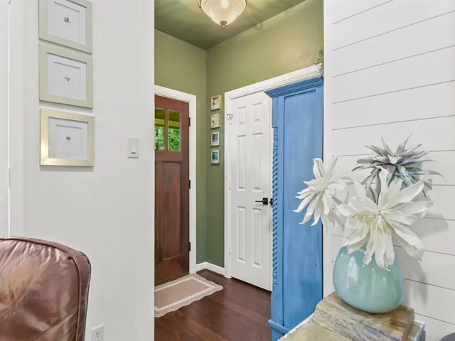 a view of a bedroom with wooden floor