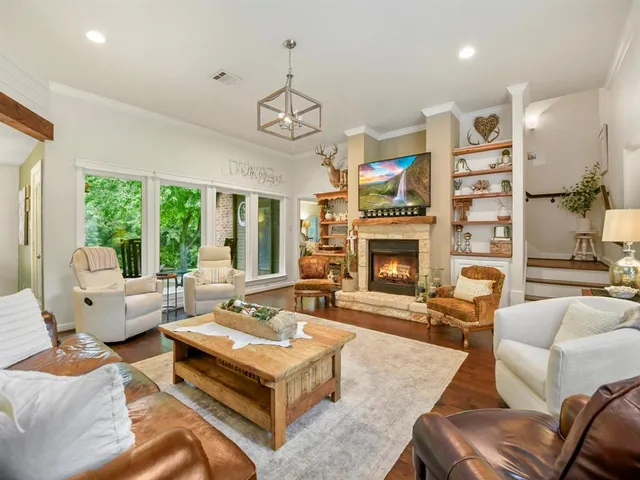 a living room with furniture fireplace and a large window