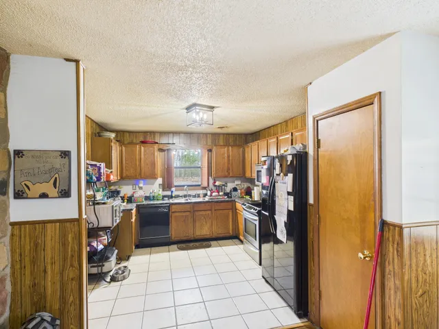 a kitchen with stainless steel appliances granite countertop a refrigerator and a stove