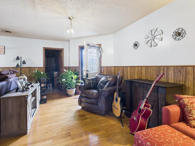 a living room with furniture gym equipment and a chandelier