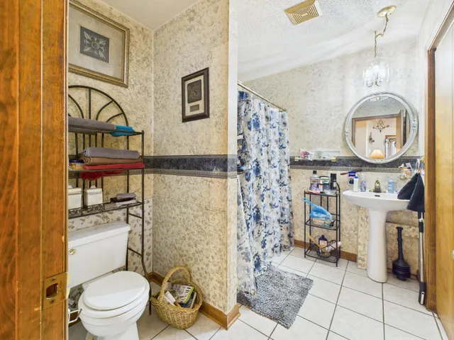 a bathroom with a toilet a sink and a mirror