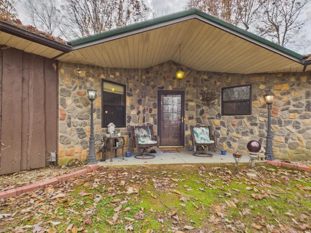 a backyard of a house with table and chairs