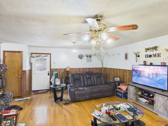 a living room with furniture and wooden floor