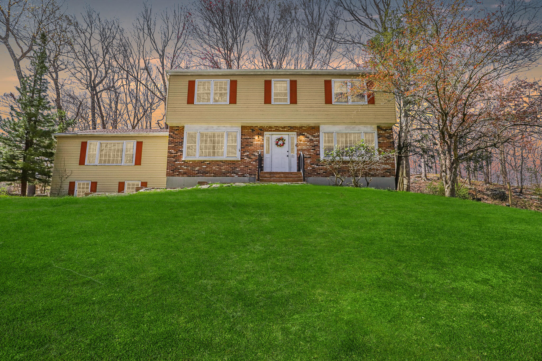 a front view of a house with a garden