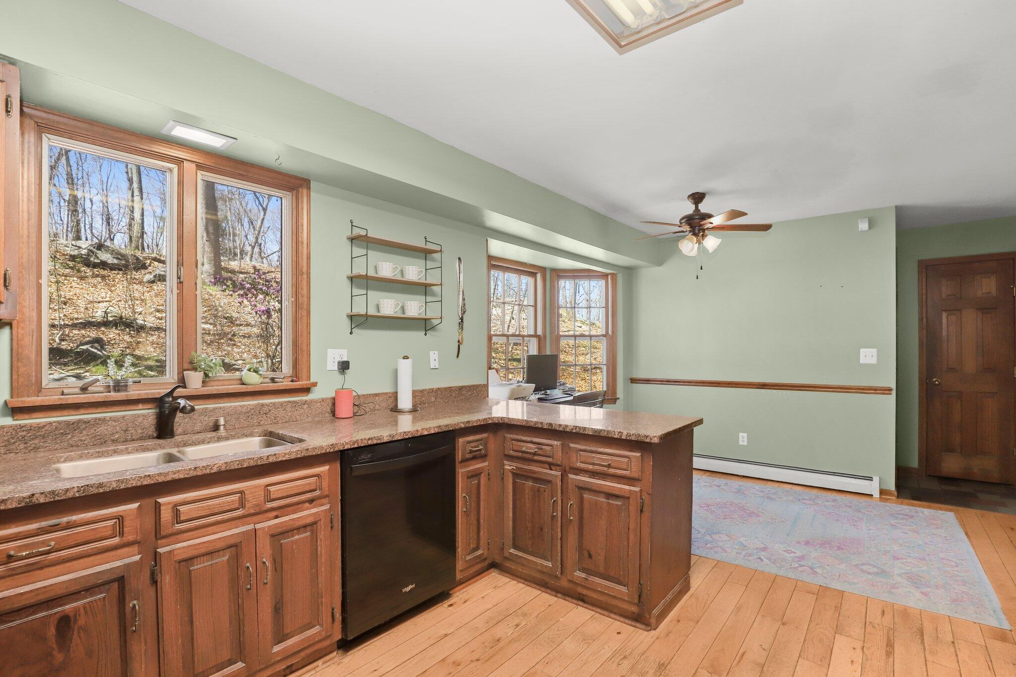 7 Allen Way Bethel, CT 06801 - Photo 12 of 31 a kitchen with a sink and wooden cabinets