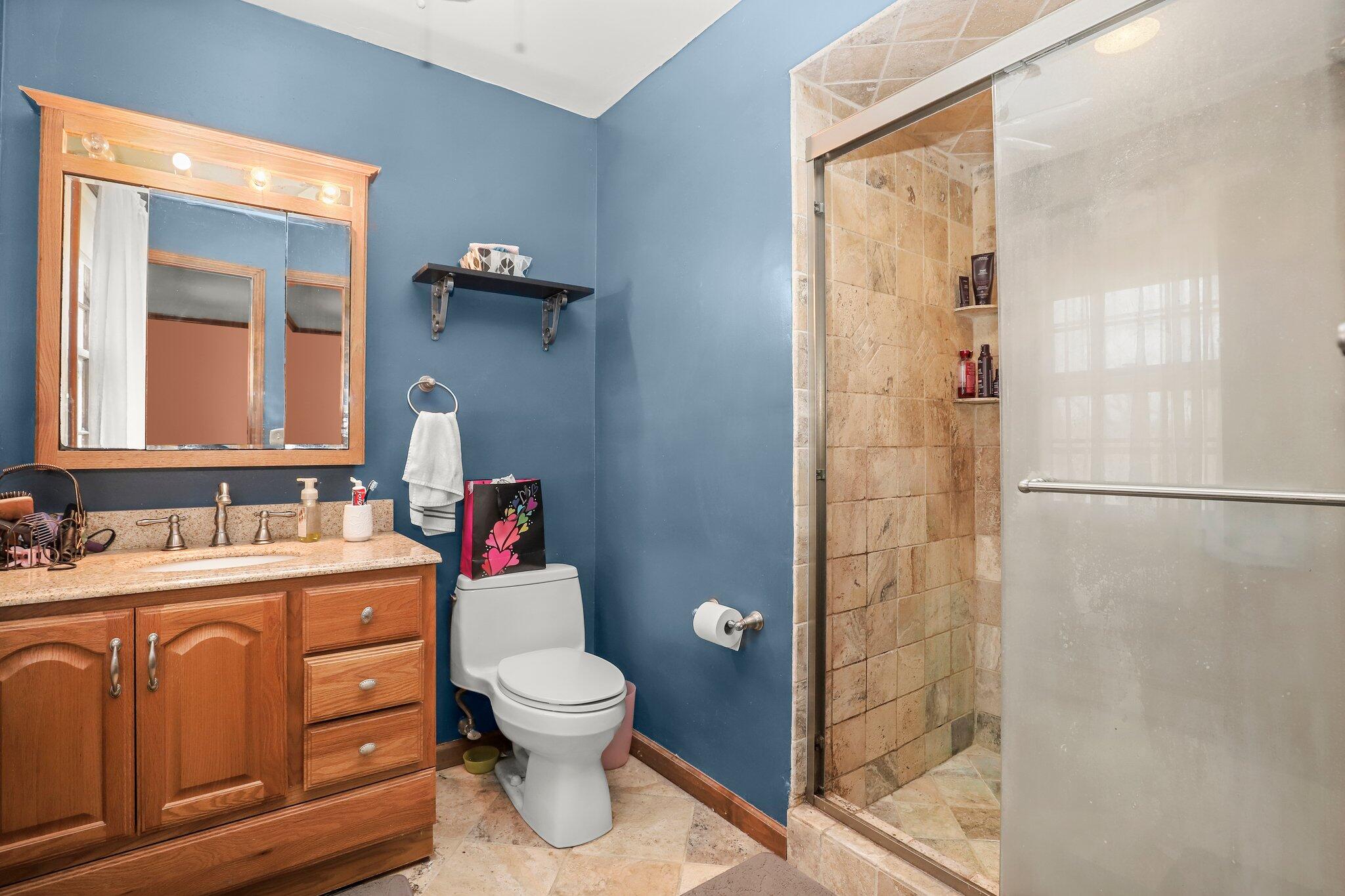 7 Allen Way Bethel, CT 06801 - Photo 20 of 31 a bathroom with a toilet sink vanity and shower