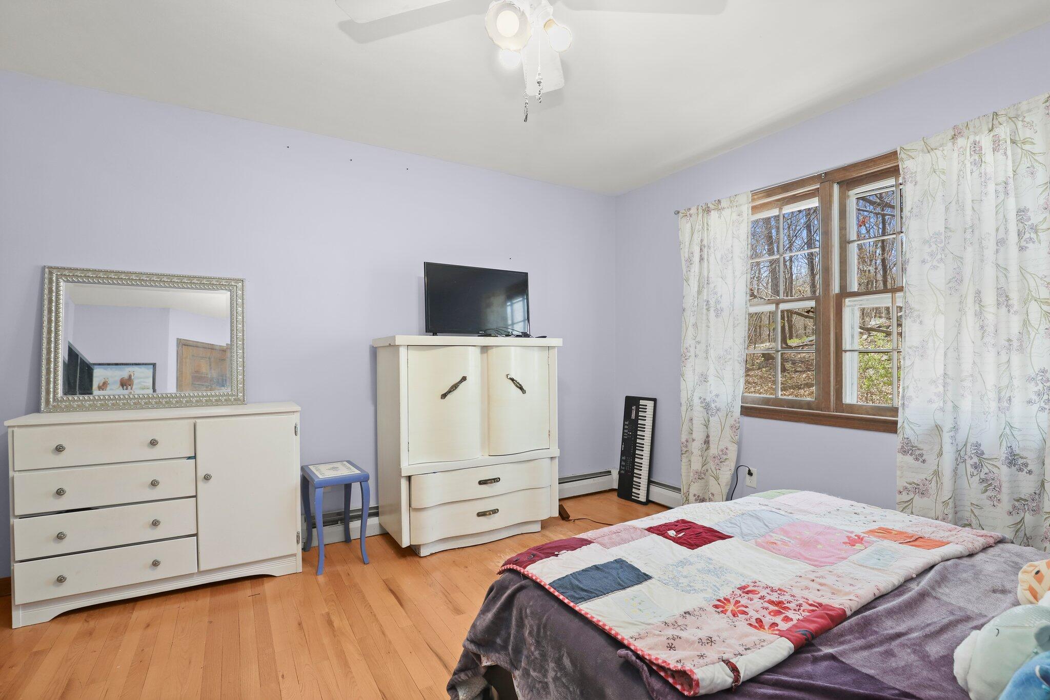 7 Allen Way Bethel, CT 06801 - Photo 23 of 31 a bedroom with a bed and a dresser in it