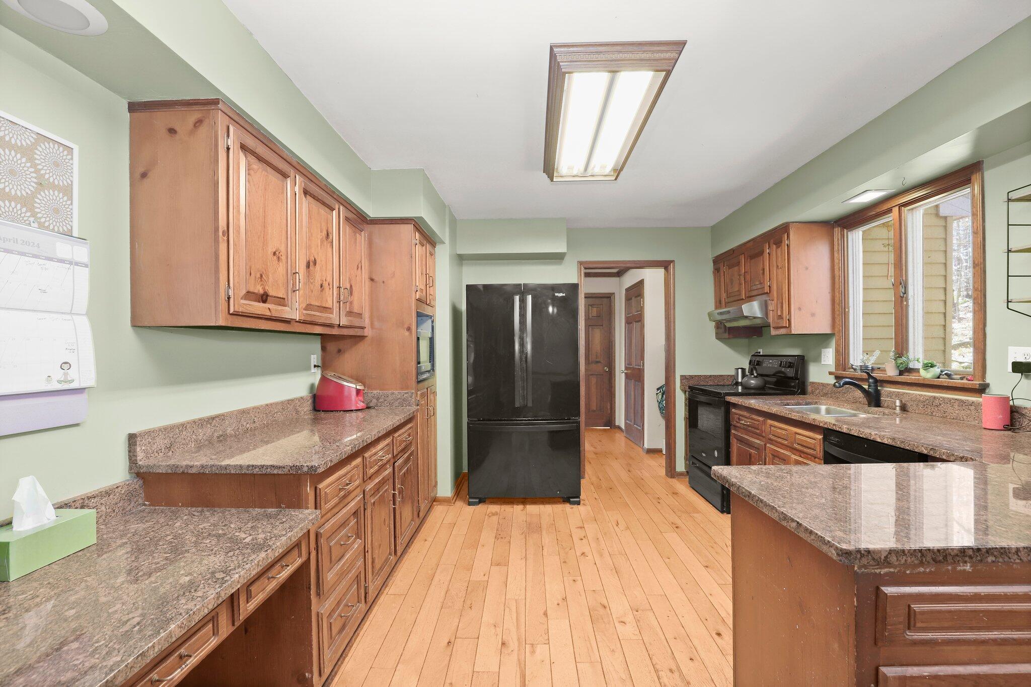 7 Allen Way Bethel, CT 06801 - Photo 10 of 31 a kitchen with granite countertop a stove a sink dishwasher a refrigerator and cabinets with wooden floor
