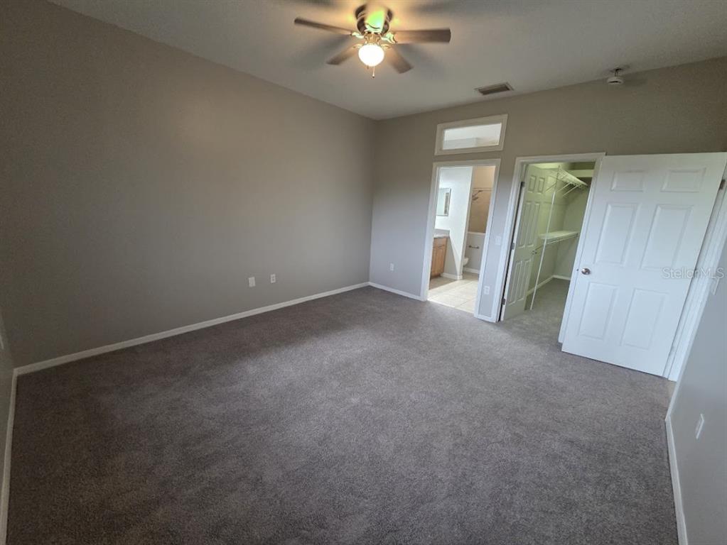 2642 Rutledge Court Winter Haven, FL 33884 - Photo 5 of 6 an empty room with chandelier fan and windows