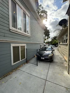 a couple of cars parked in front of a house