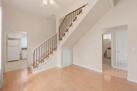 a view of staircase with white walls and a window