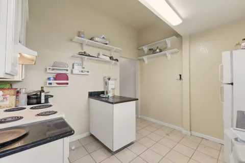 a kitchen with stainless steel appliances granite countertop a refrigerator and a stove