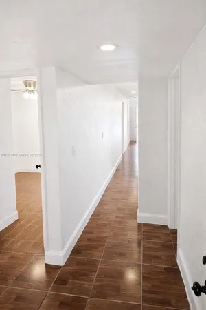 a view of hallway with wooden floor