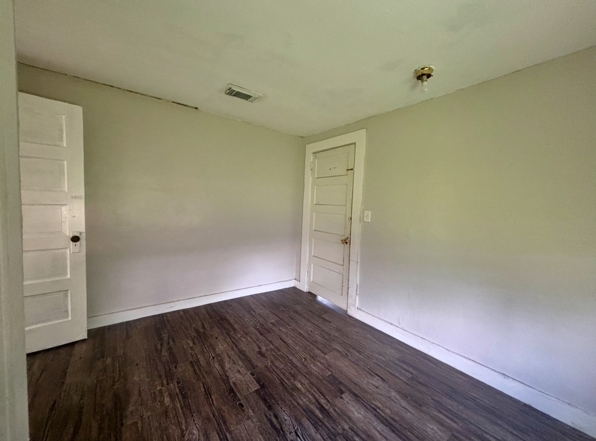 701 North Hackberry Street Sweeny, TX 77480 - Photo 10 of 12 an empty room with wooden floor