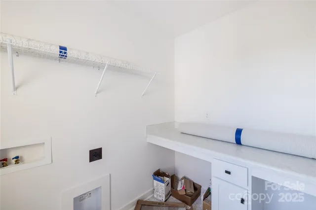 a view of storage and utility room with racks on the wall