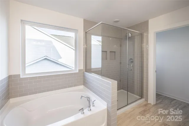 a white bath tub sitting next to a shower
