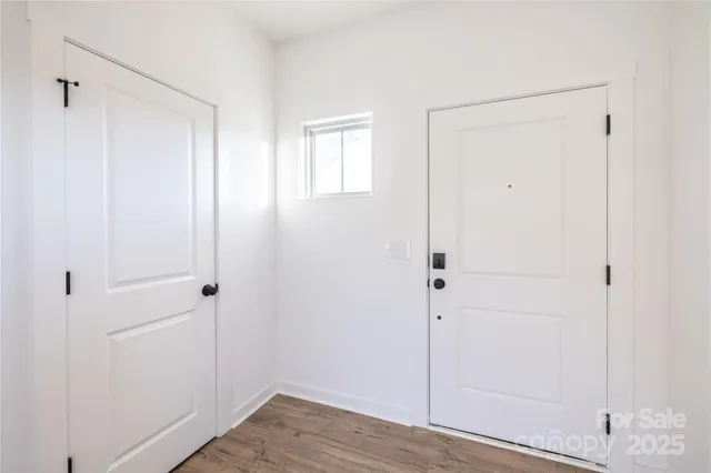 a view of a closet area with wooden floor