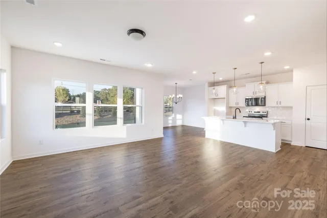 a view of kitchen with kitchen island sink stainless steel appliances and cabinets