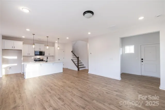a view of kitchen with kitchen island white cabinets and refrigerator