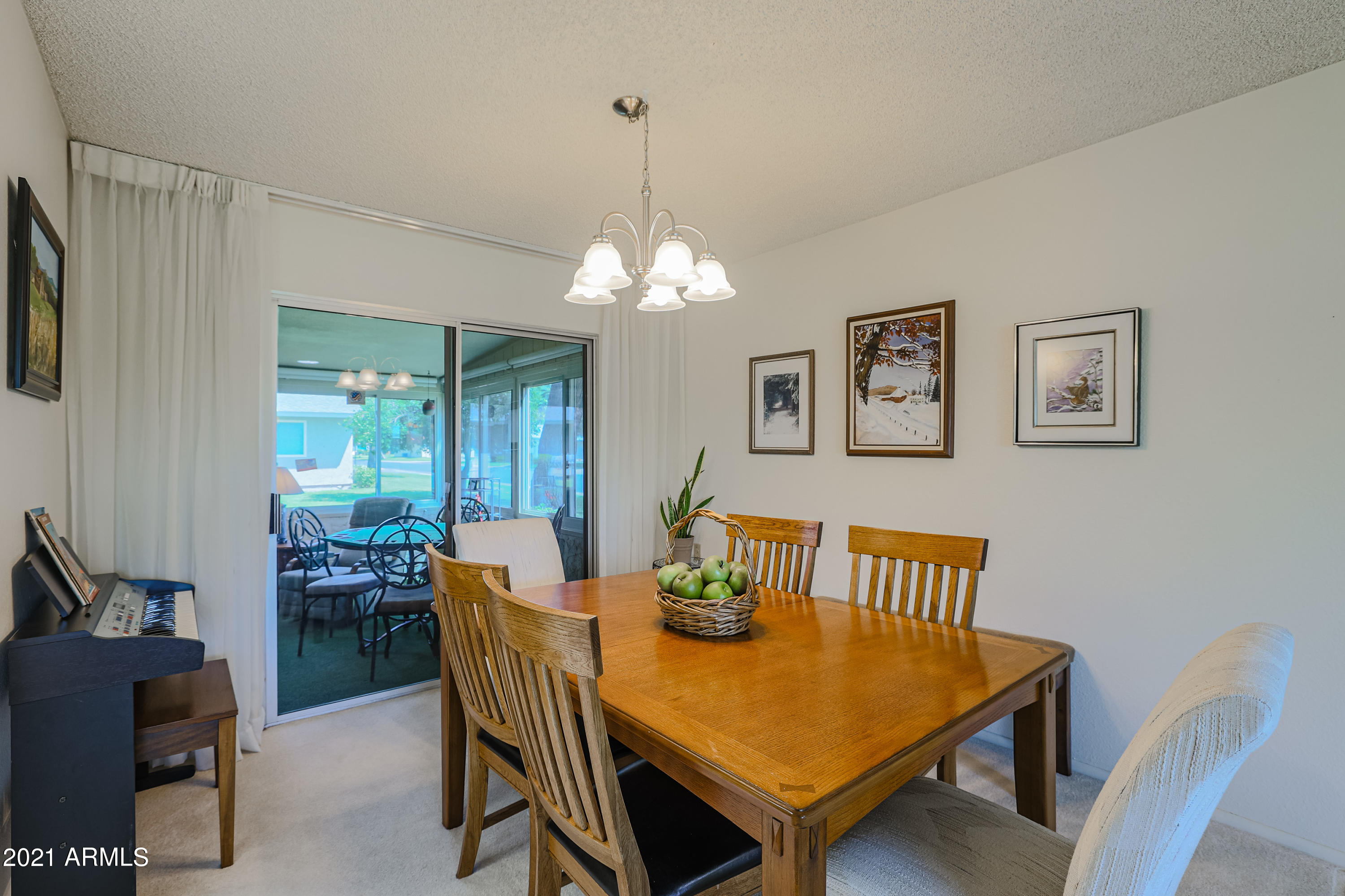 630 Leisure World Mesa, AZ 85206 - Photo 12 of 59 a view of a dining room with furniture and chandelier