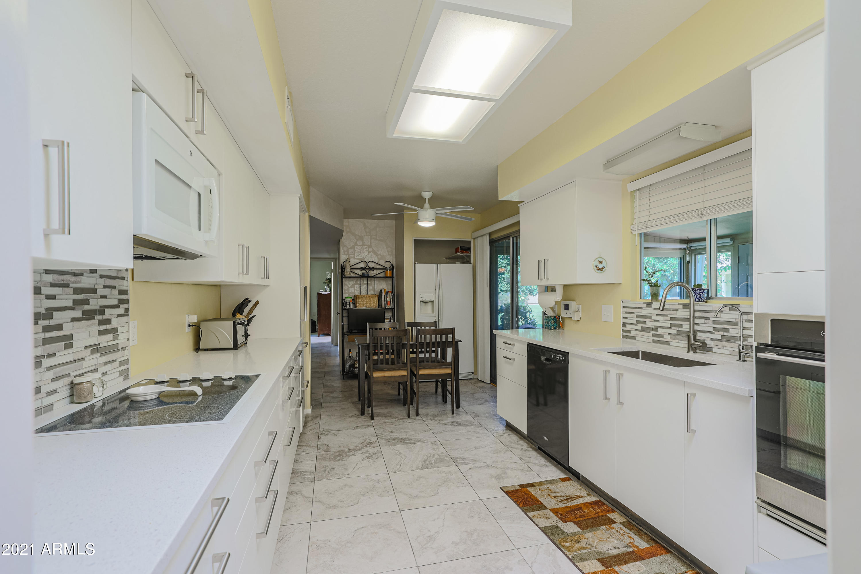 630 Leisure World Mesa, AZ 85206 - Photo 13 of 59 a kitchen with stainless steel appliances kitchen island granite countertop a sink and cabinets
