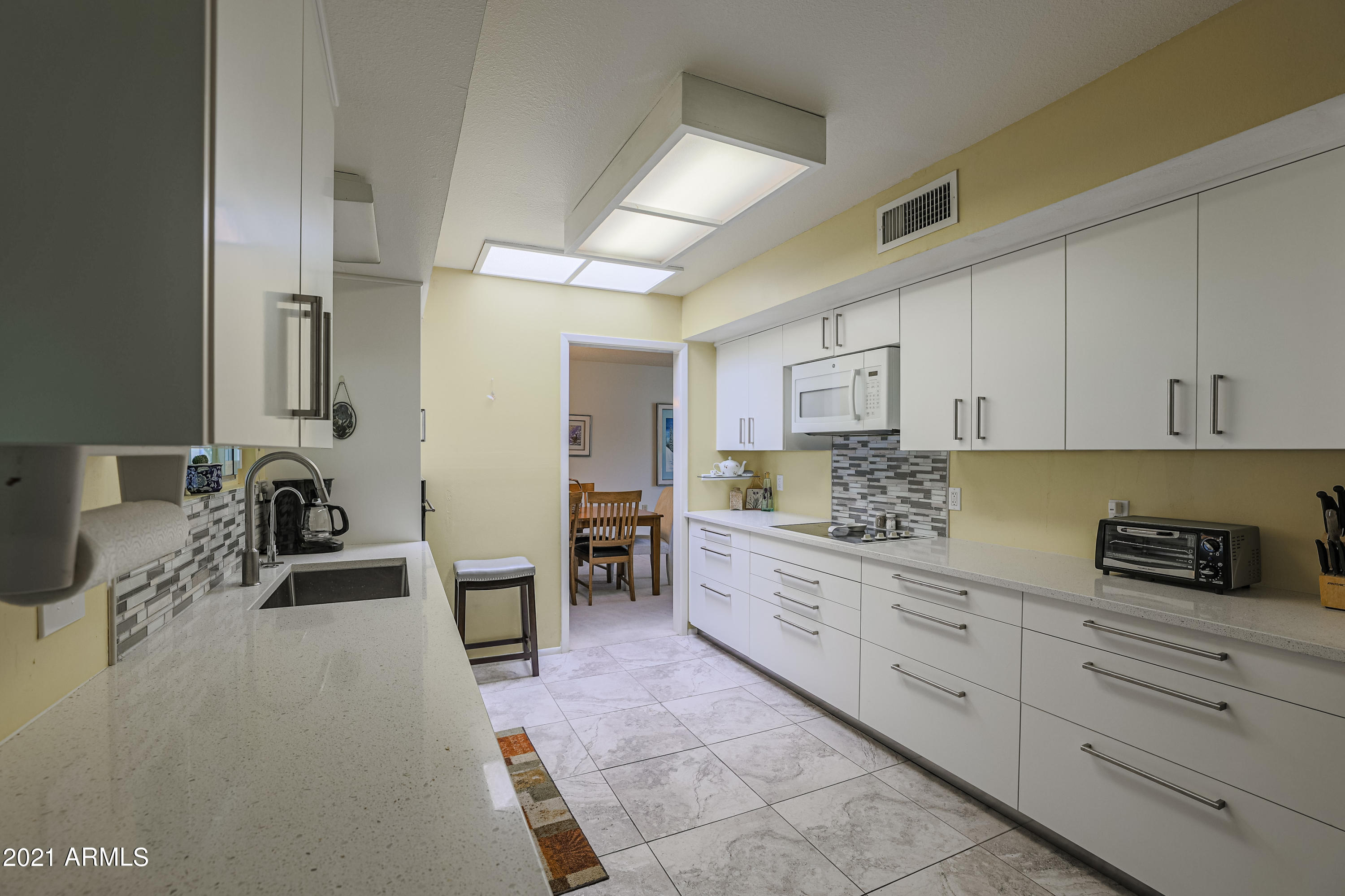 630 Leisure World Mesa, AZ 85206 - Photo 18 of 59 a kitchen with cabinets stainless steel appliances and a counter top space