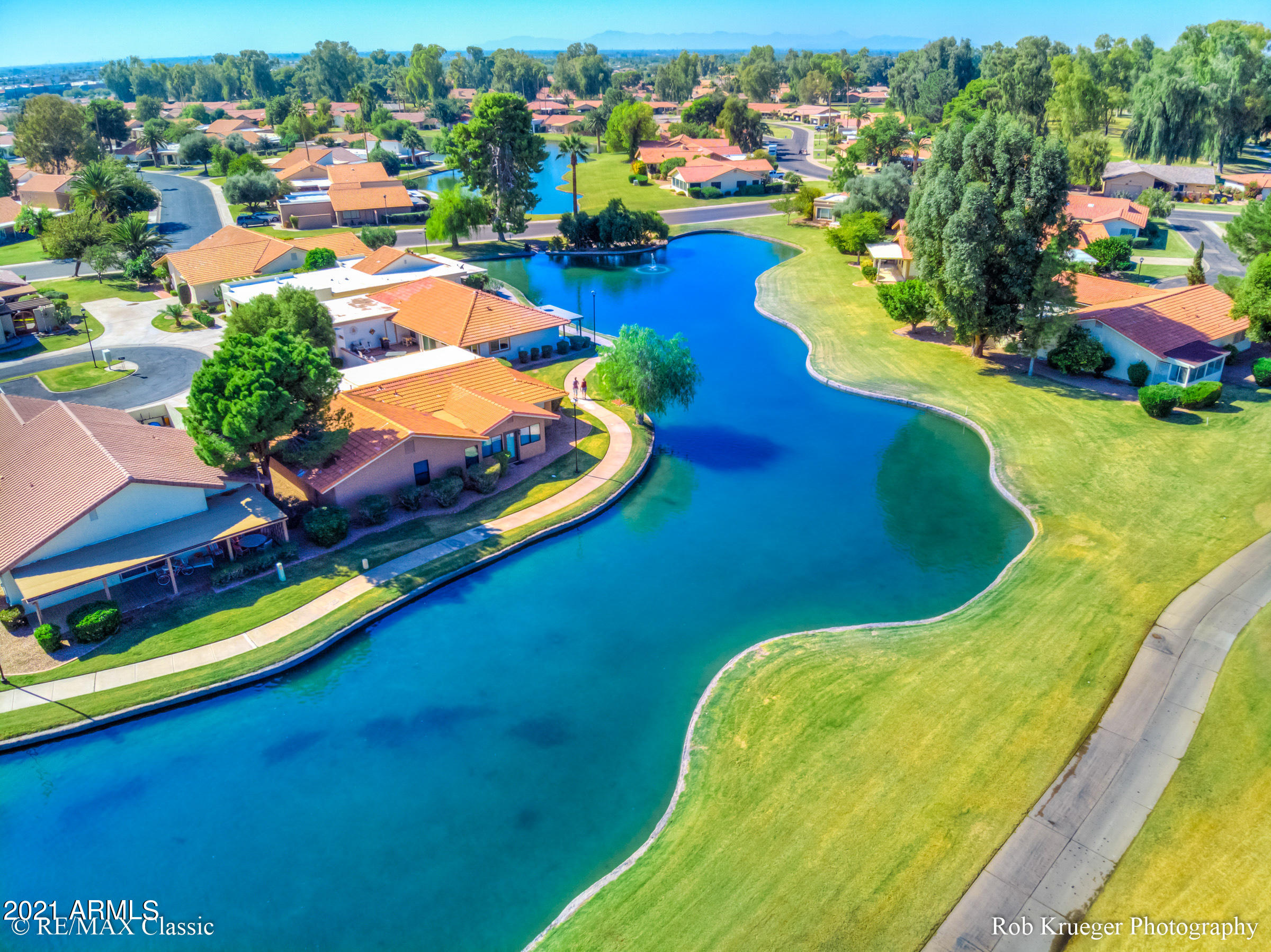 630 Leisure World Mesa, AZ 85206 - Photo 37 of 59 a view of a swimming pool with a yard and mountain view in back