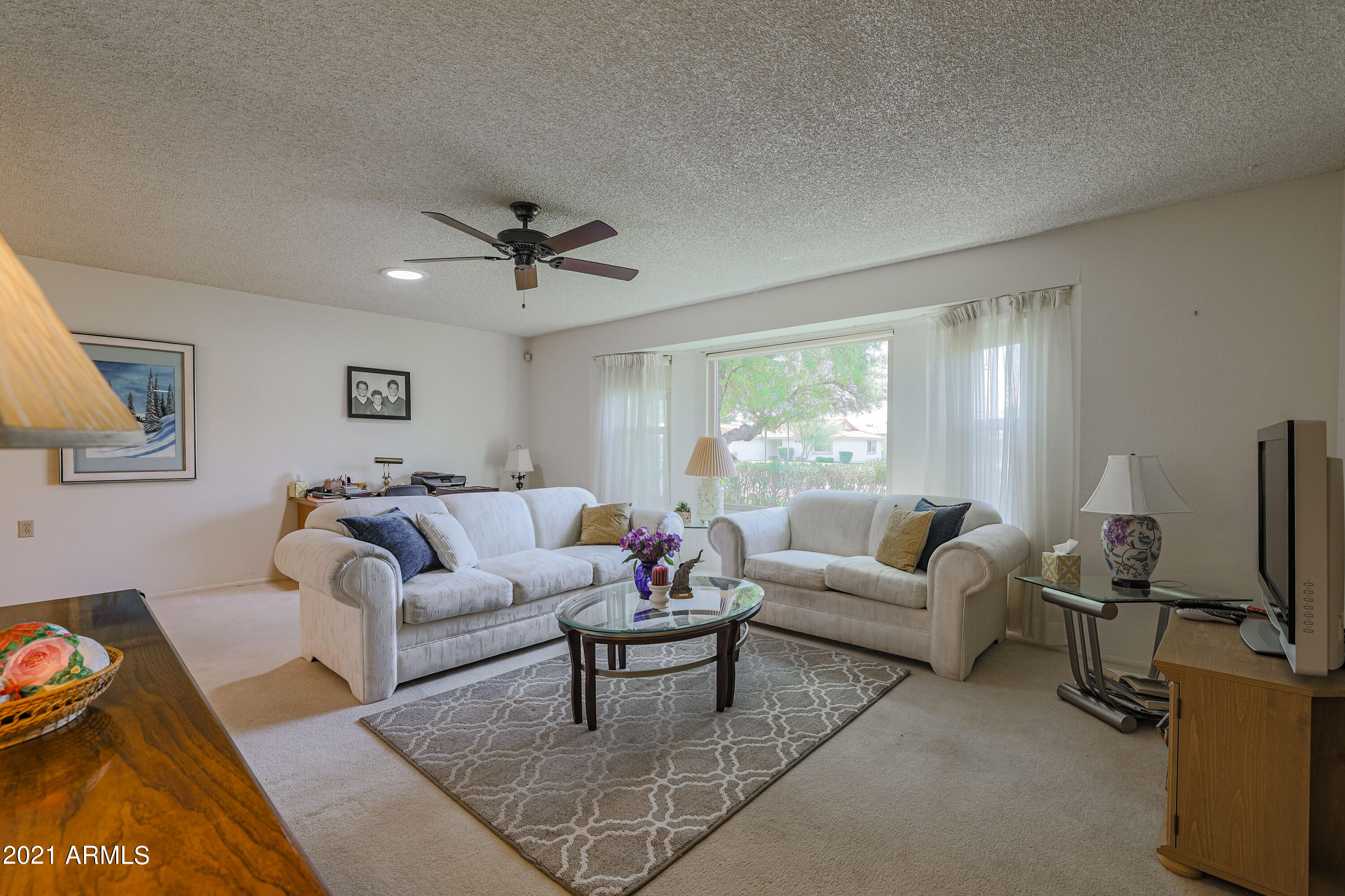 630 Leisure World Mesa, AZ 85206 - Photo 7 of 59 a living room with furniture a ceiling fan and a window